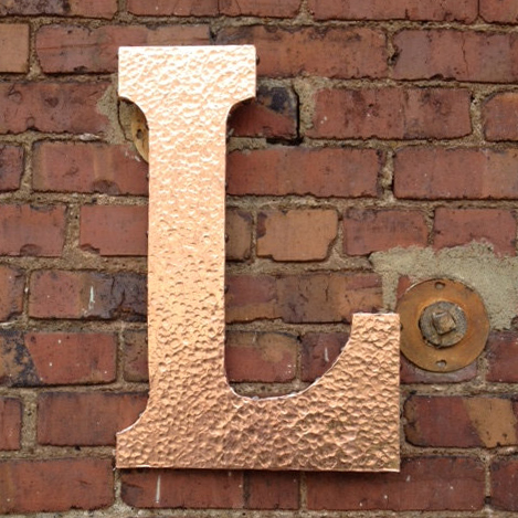 A hammered metal letter 